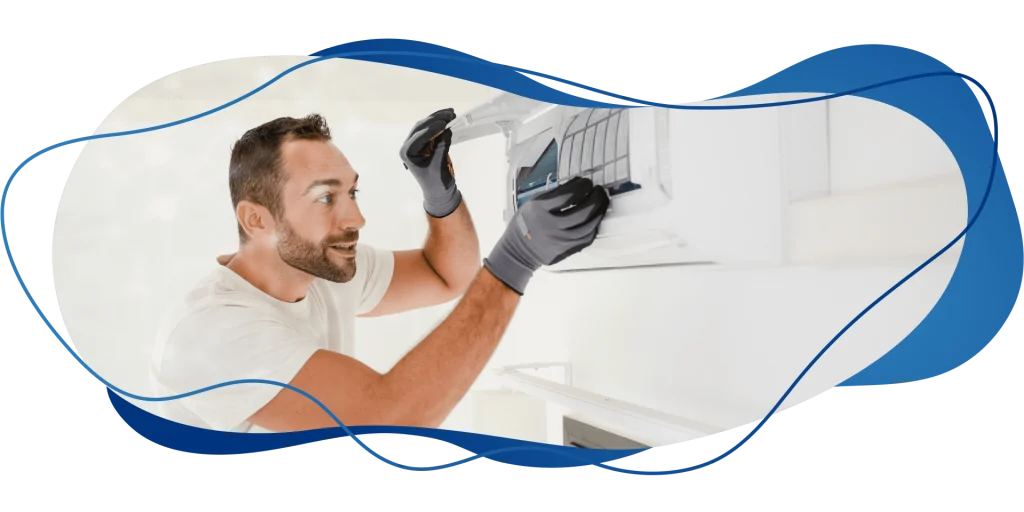 Técnico sorridente abrindo o ar condicionado split para manutenção